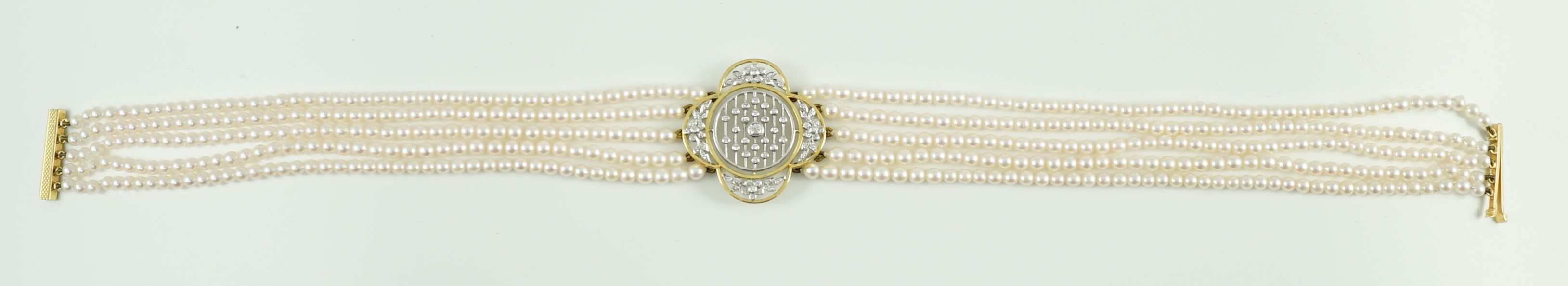 A quintuple strand seed pearl choker necklace, with pierced gold, platinum and diamond cluster set quatrefoil shaped clasp